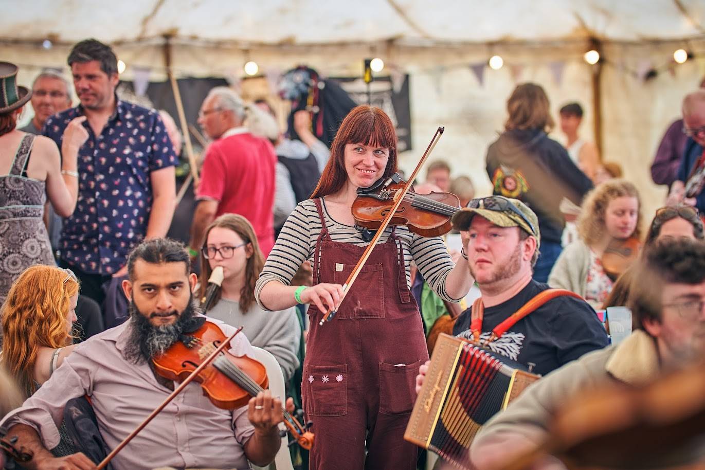 A session in the bar, an informal group of musicians play instruments includeing fiddle, recorder and melodeon