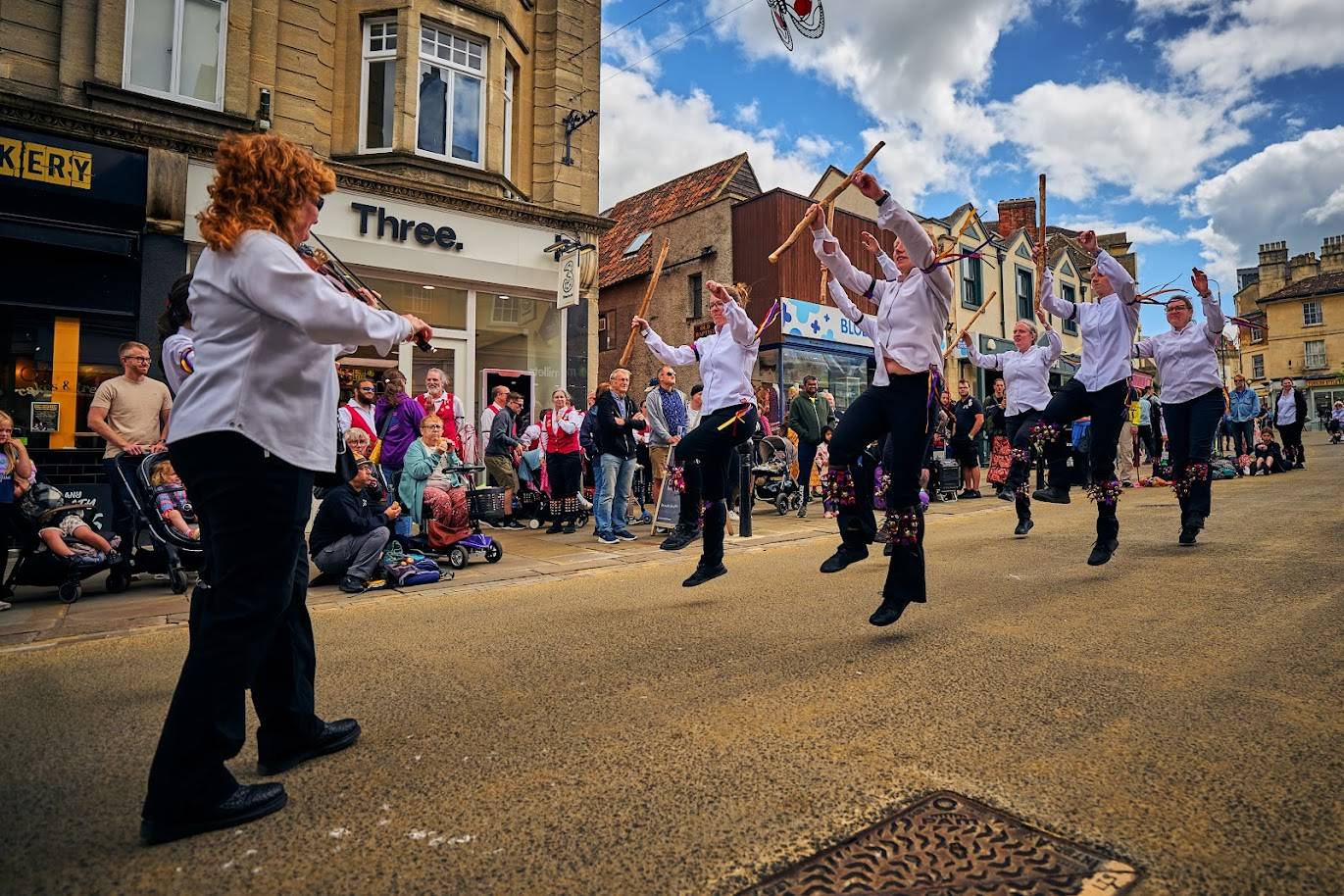 Pecsaetan Morris dancing in Chippenham High Street to the music of a fiddle player